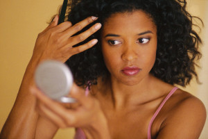 Woman Checking Hair in Mirror